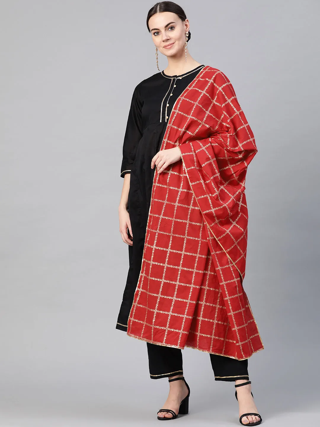 Black and golden solid kurta with trousers with Red Dupatta.