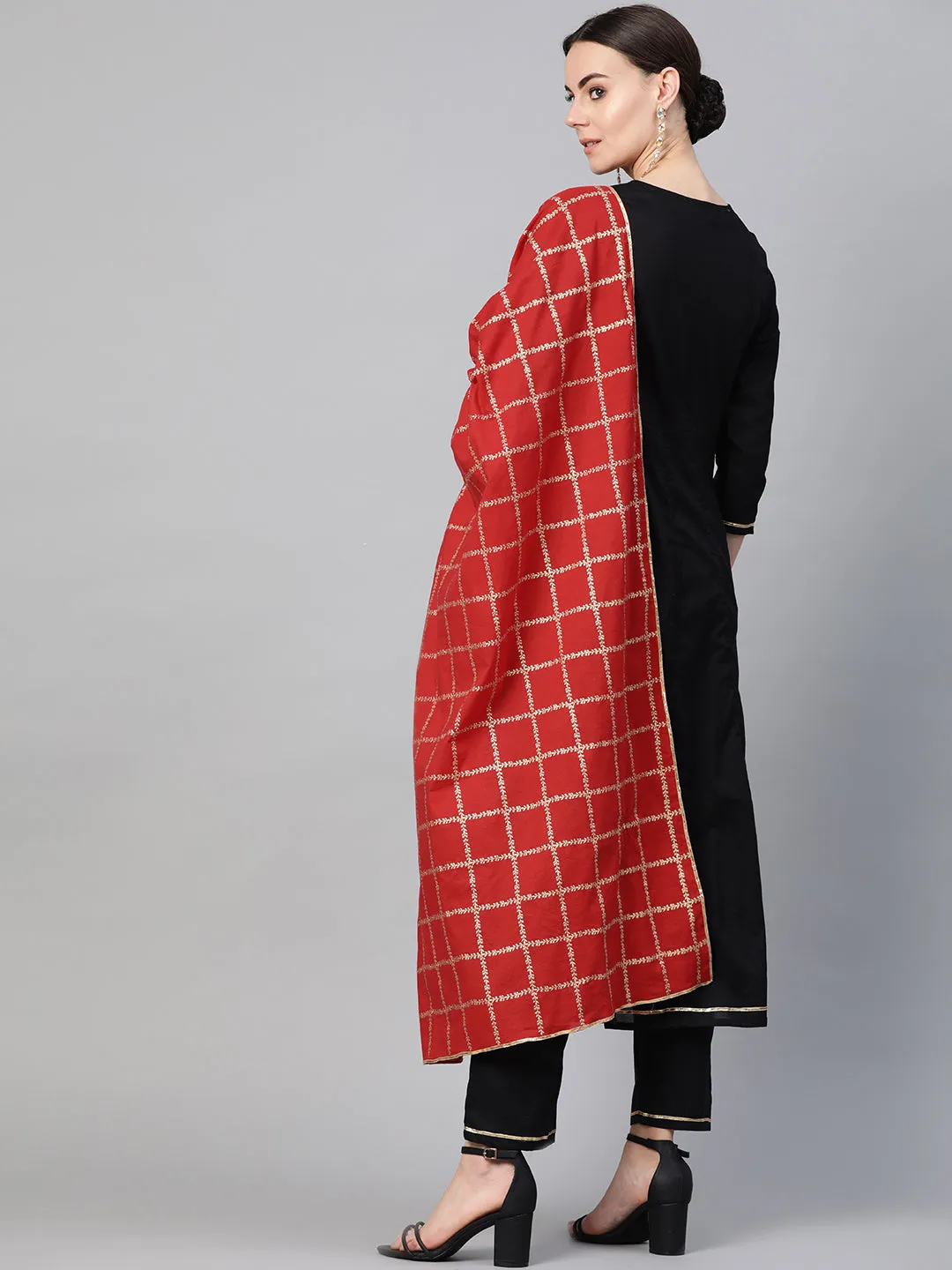 Black and golden solid kurta with trousers with Red Dupatta.