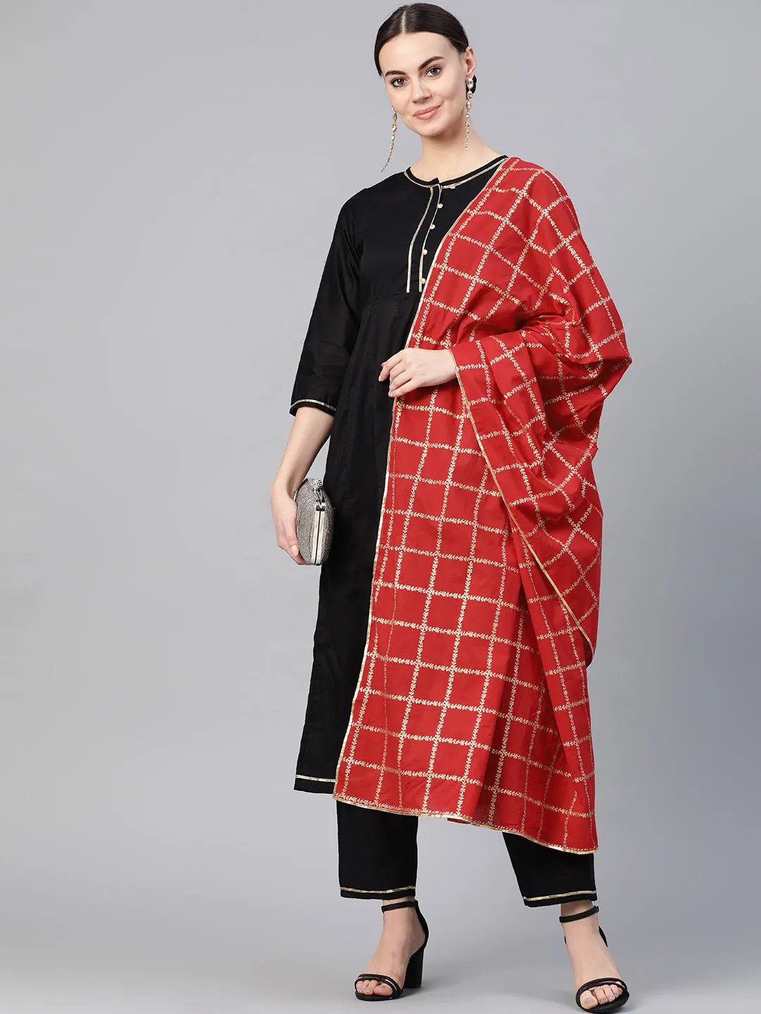 Black and golden solid kurta with trousers with Red Dupatta.