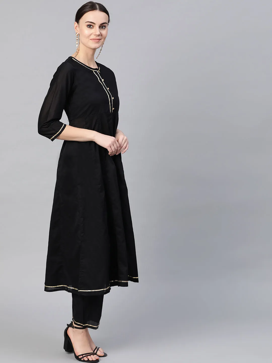 Black and golden solid kurta with trousers with Red Dupatta.